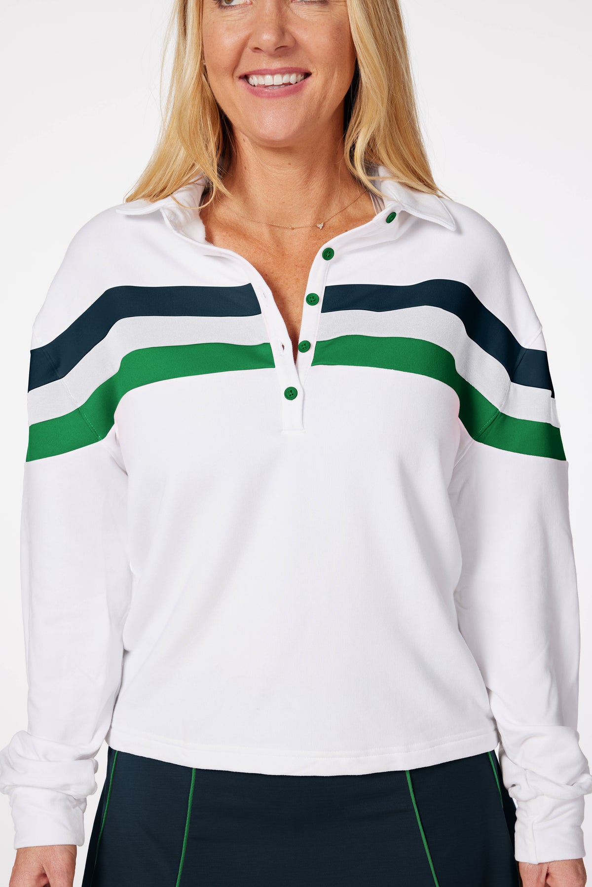 women wearing golf pullover called the Murray. white with green and teal stripes