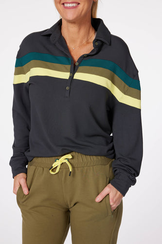 Model wearing Teal Murray women's golf long sleeve collared shirt and olive green ace womens golf joggers.
