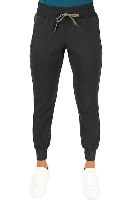Bottom half of a woman wearing black golf joggers.