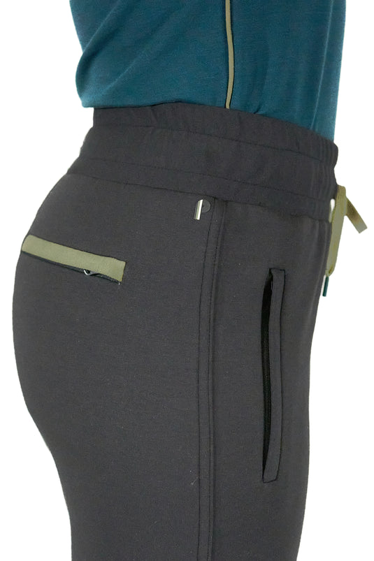 Model wearing black women's golf joggers highlighting pocket contrast in a studio shot.