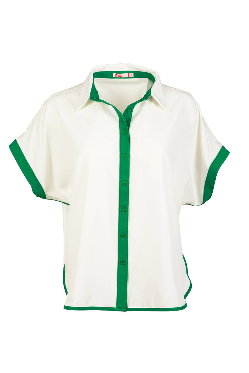 Load image into Gallery viewer, White and green Caddy Camp golf shirt in flat lay studio shot.
